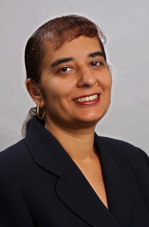 Surita Bhatia, wearing a black professional top and smiling