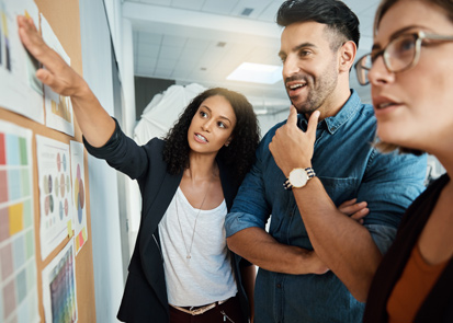 Business people putting up Post-its on shared wall