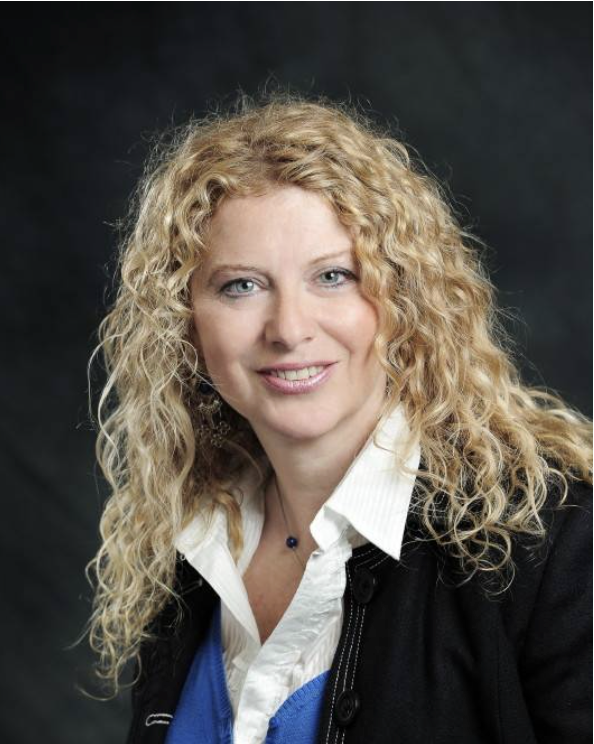 Headshot of a woman with curly blond hair