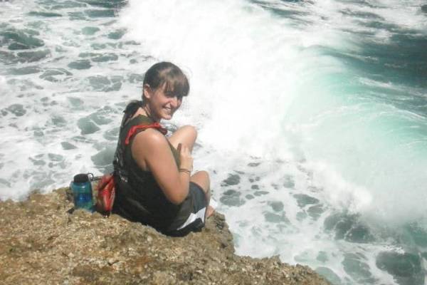 Celeste Stout sits at the beach looking back over her shoulder